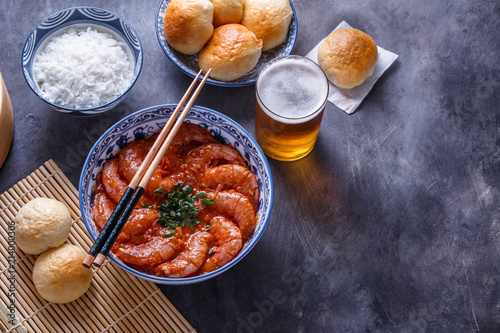 Bowl of shrimps with chopsticks, rice and beer, copyspace
