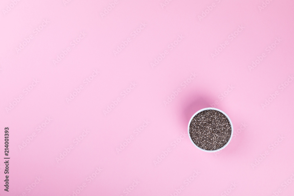 Seeds of Chia on the pink background.Trendy Bright Colors. Concept. Minimalism. Healthy Food. Vegetarian. Diet Nutrition. Top View. Flat Lay. Copy space for Text. Seeds of Chia on the pink background.Trendy Bright Colors. Concept. Minimalism. Healthy Food. Vegetarian. Diet Nutrition. Top View. Flat Lay. Copy space for Text.
