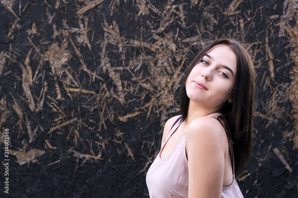 Girl with nice appearance standing against wall Girl with nice appearance standing against wall