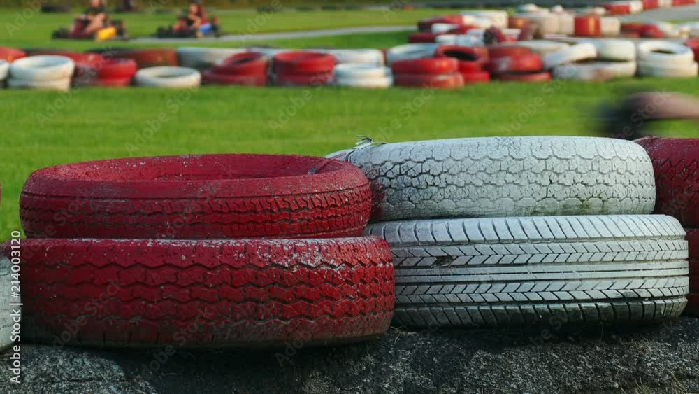 4K: Go Karts Race Around Track Behind Tire Bumpers