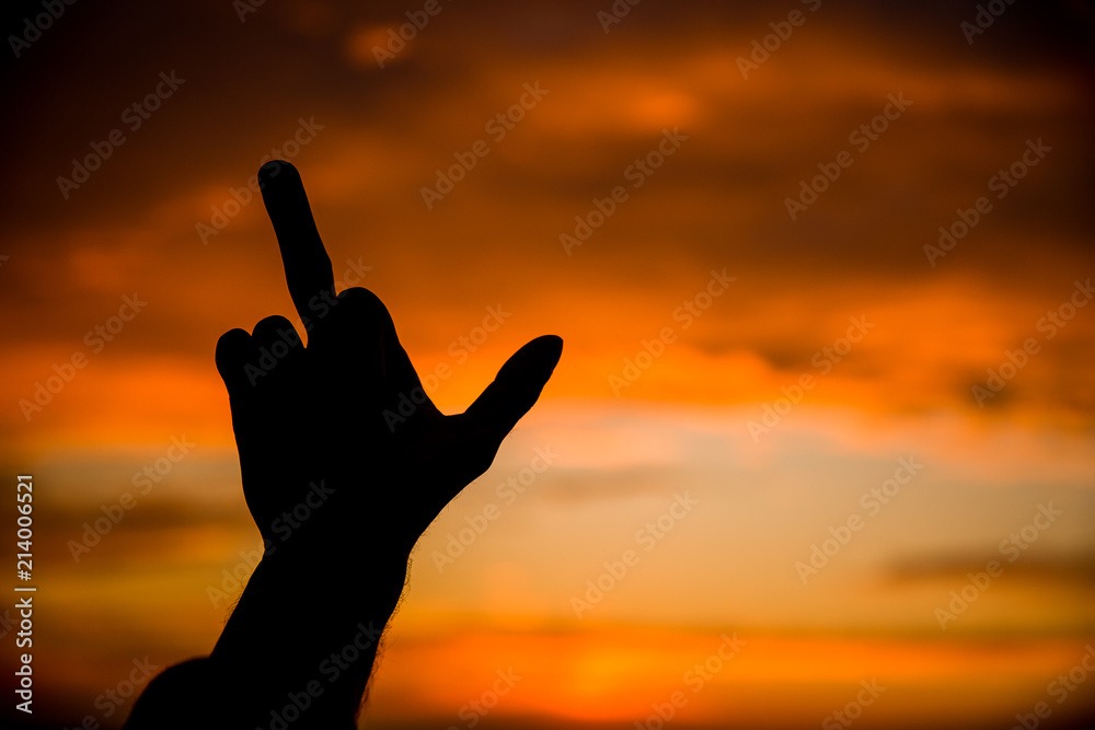Fuck.Thumbs up.Photo at sunset.Hand.Silhouette photo