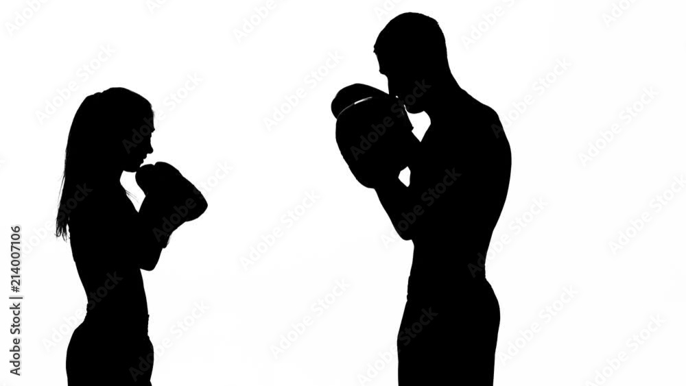 Development of straight kicks kickboxing on boxing paws. Silhouette. White background