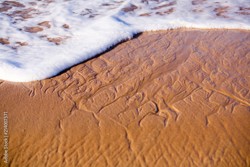 Textured sand and waves