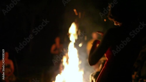 Women dancing around the fire at night