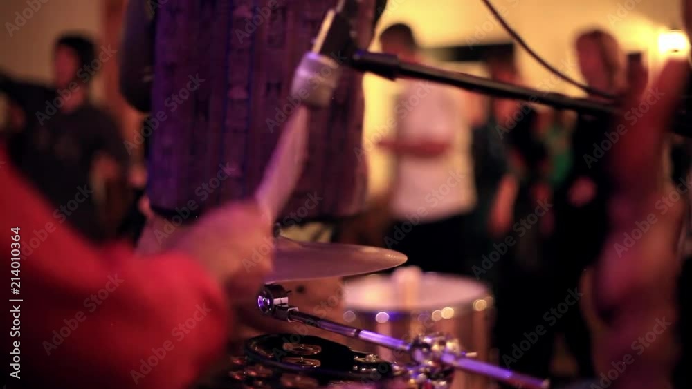 Acoustic drummers playing djembe, drums, and toms live Acoustic drummers playing djembe, drums, and toms live