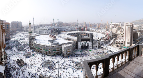 MECCA, SAUDI ARABIA - MAY 02 2018: Outstanding wide panoramic view on entire Masjid Al Haram mosque from Clock Tower Abraj Al Bait. Visible center to horizon, aerial skyline view. Crowd of people down