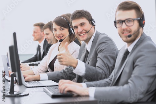 employee call center with headset showing thumb up