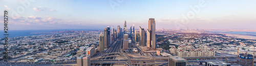 DUBAI  UAE - FEBRUARY 21  2014. Panorama aerial view on Dubai main street - Sheikh Zayed Road and skyscrapers in evening on sunset