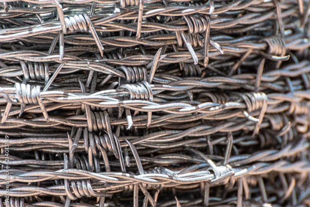 Close up on a pile/ roll of shiny new barbed wire. Close up on a pile/ roll of shiny new barbed wire.