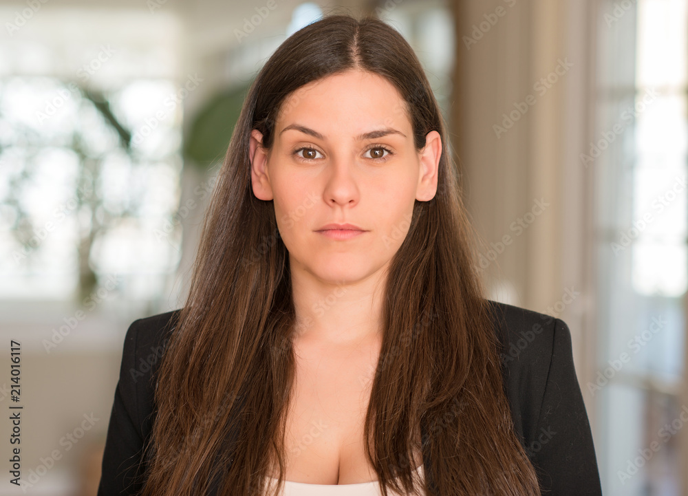 Young beautiful woman at home with a confident expression on smart face thinking serious Young beautiful woman at home with a confident expression on smart face thinking serious