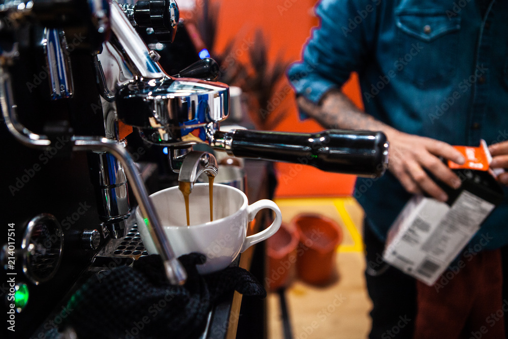 Fancy stainless steel coffee machine pouring a double espresso in a coffee shop