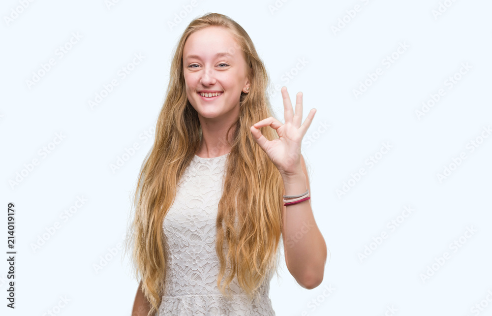 Blonde teenager woman doing ok sign with fingers, excellent symbol Blonde teenager woman doing ok sign with fingers, excellent symbol