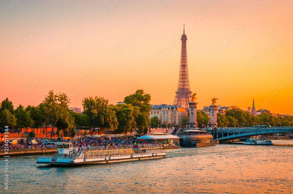 Sunset view of Eiffel Tower, Alexander III Bridge and river Seine in Paris, France.