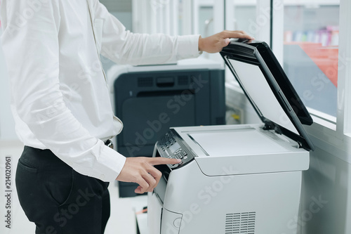 Fotografie Bussiness man Hand press button on panel of printer scanner or laser copy machin