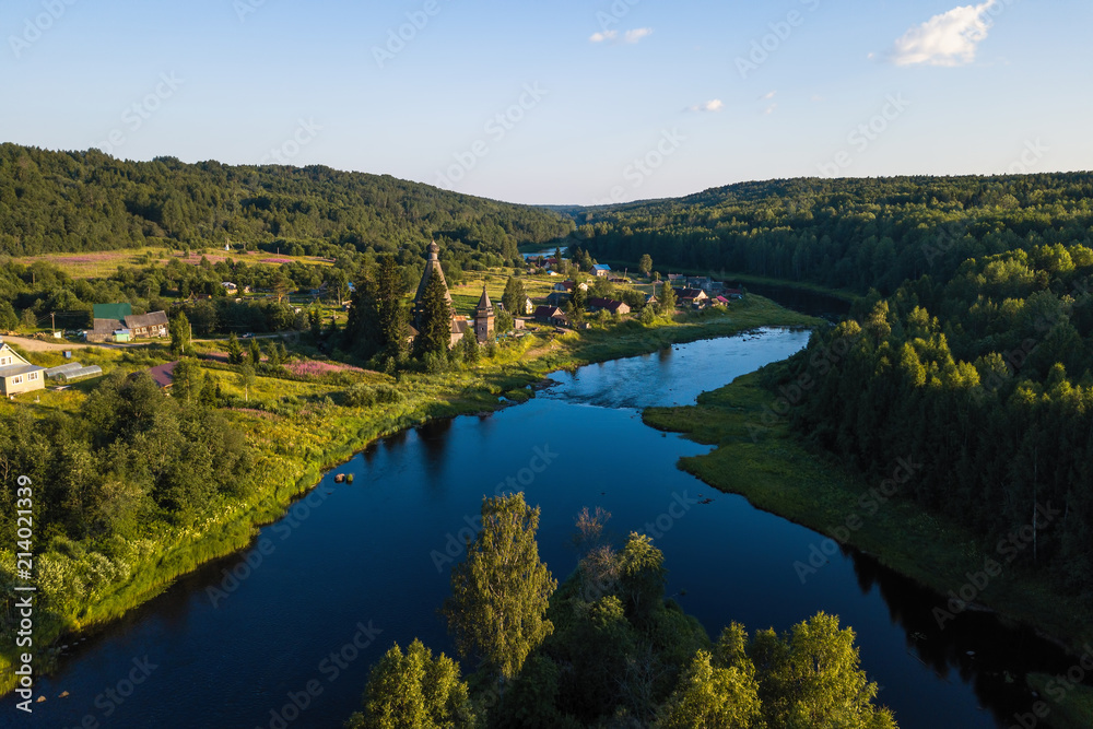 Fototapeta premium Bird's eye view of the Vazhinka river in Soginicy village, Podporozhysky district. Green forests of Leningrad region and Republic of Karelia, Russia.