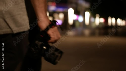 photograph walking with camera at night, closeup to bokeh photo