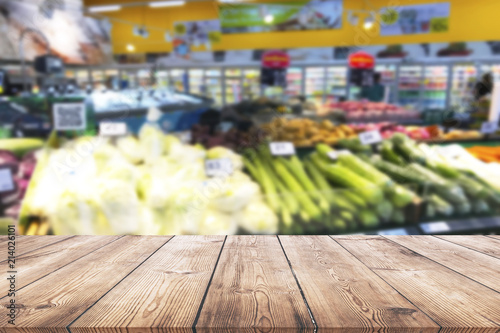 Empty wood table top on shelf in supermarket blurred background