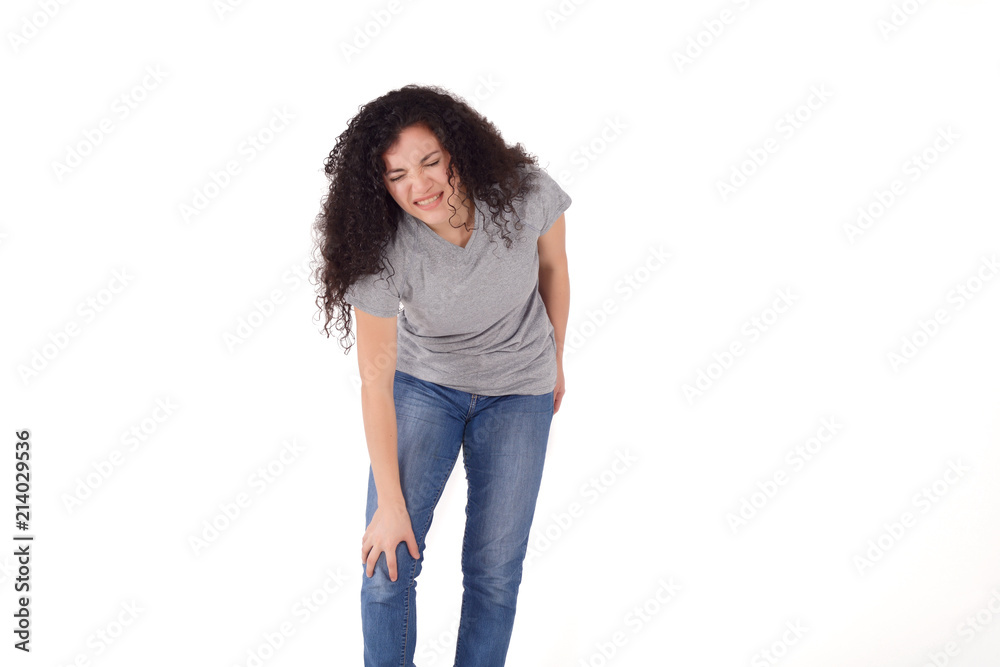 Young latin woman with pain in knee. Young latin woman with pain in knee.
