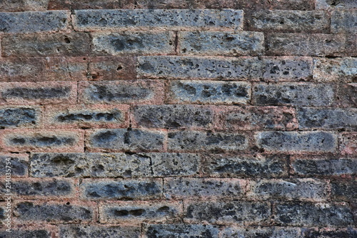 Dark brick wall. Original design background. Brickwork without cement of the ancient building of the fortress in Wetneme. Nha Trang