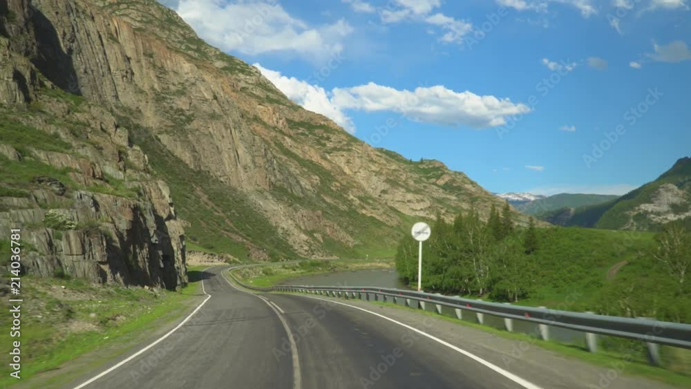 Beautiful mountain road. Movement of the camera. Blue sky and clouds. Beautiful mountain road. Movement of the camera. Blue sky and clouds.