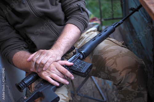 soldier loading a bunch of bullets into a handgun magazine