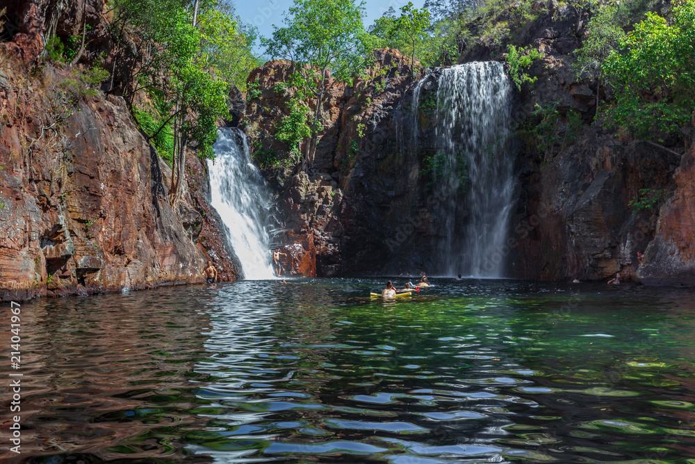 Naklejka premium Landscape view of young people swimming under Florence Falls in the Litchfield National Park, Northern Territory, Australia