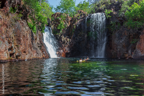 Landscape view of young people swimming under Florence Falls in the Litchfield National Park, Northern Territory, Australia