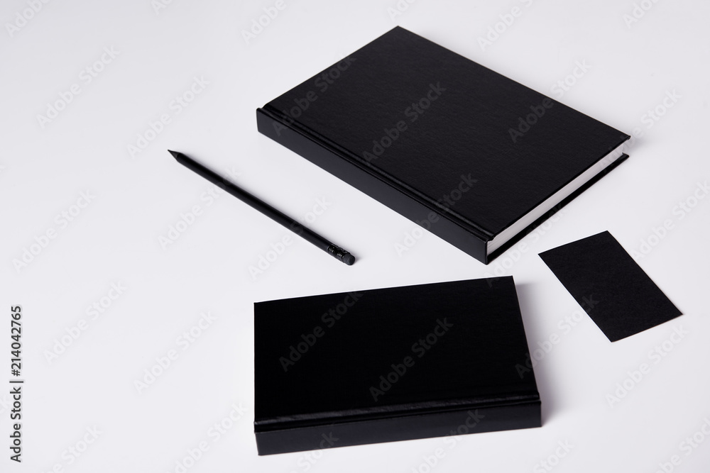 close-up shot of black notebooks on white surface for mockup close-up shot of black notebooks on white surface for mockup
