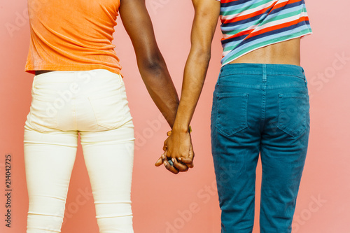 Back view of two young men holding hands