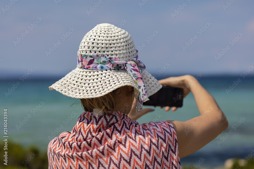 Outdoor summer portrait of pretty woman looking to the sea at tropical beach