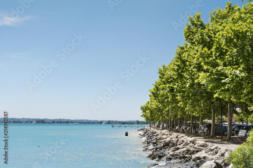 Fototapeta Naklejka Na Ścianę i Meble -  Promenade with Trees in a Row  in Bardolino ,Italy,Garda Lake 