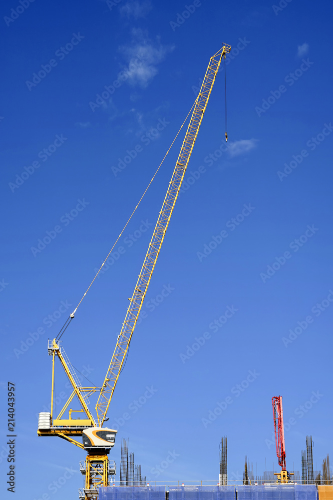 Construction crane tower on blue sky