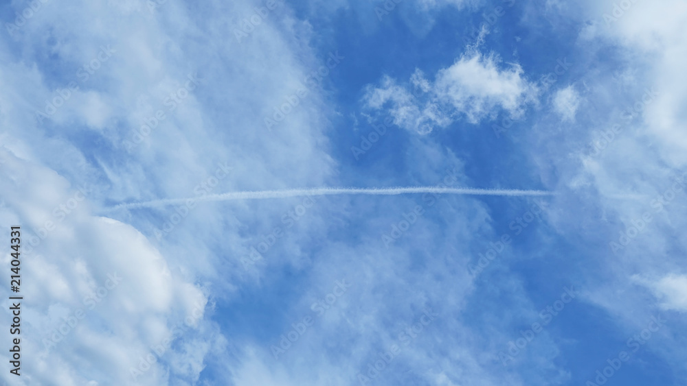 Blue sky with condensation trail of an aircraft Blue sky with condensation trail of an aircraft