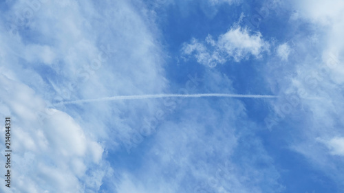 Blue sky with condensation trail of an aircraft