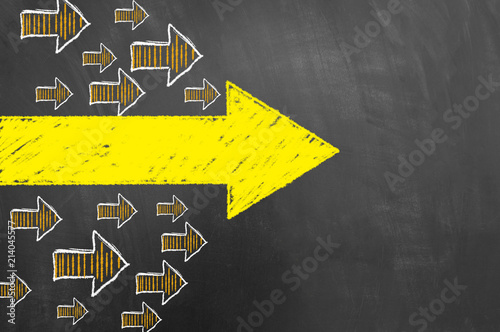 Multiple arrows yellow chalk drawing on blackboard.