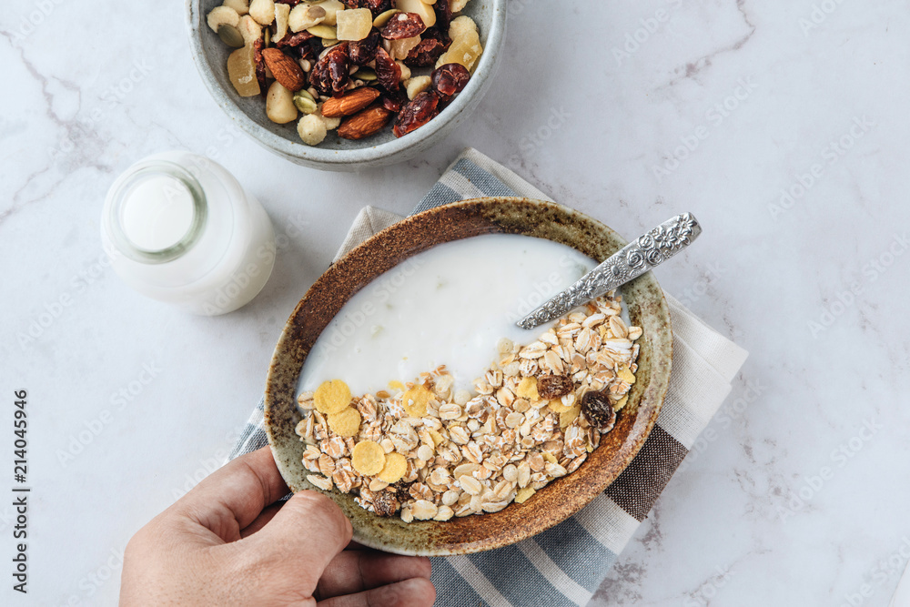 Healthy breakfast. Fresh granola, muesli with yogurt, nuts and dried berries on marble background. Healthy breakfast. Fresh granola, muesli with yogurt, nuts and dried berries on marble background.