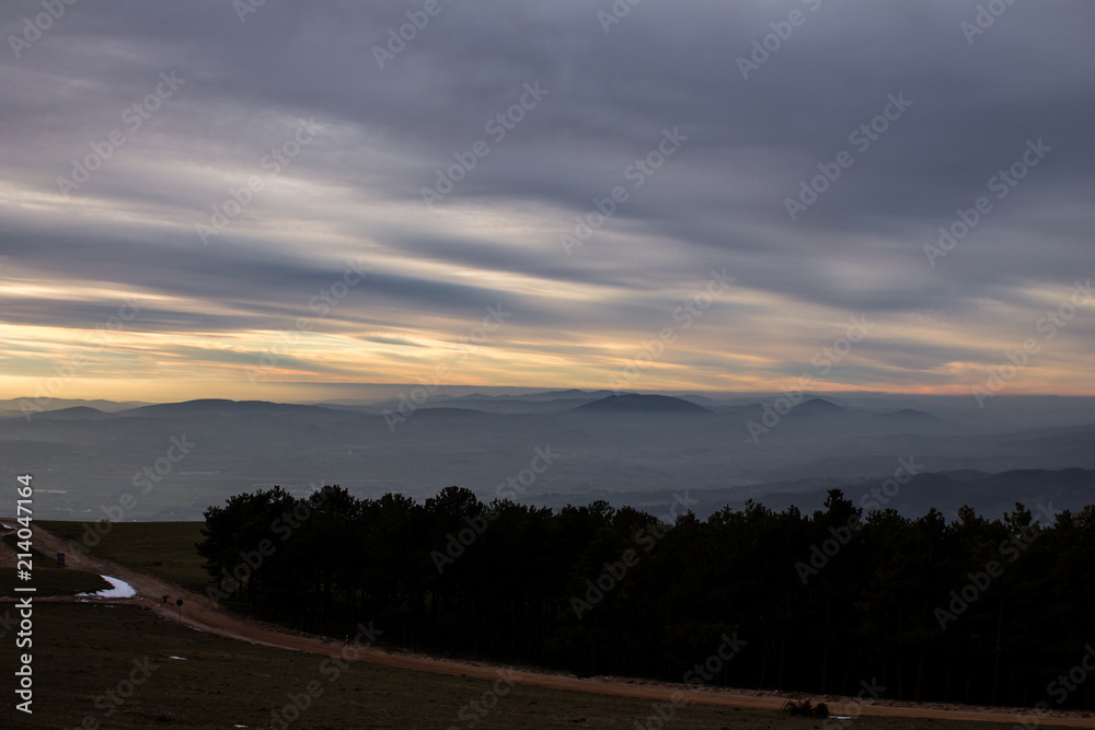 Subasio Mt. (Umbria, Italy), with sky covered by clouds and warm sunset colors
