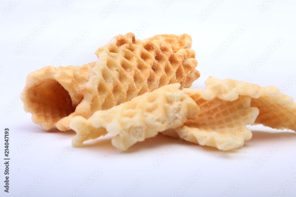 Homemade wafer rolls with powdered sugar isolated on white background Homemade wafer rolls with powdered sugar isolated on white background