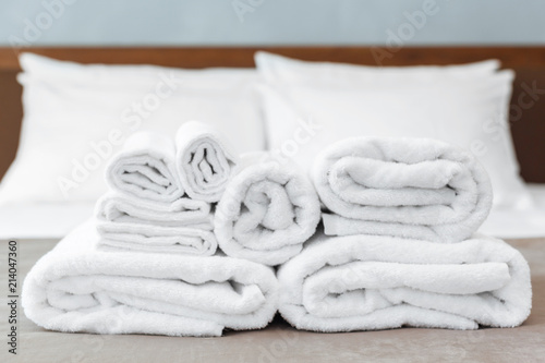 White towel on bed in guest room for hotel customer photo