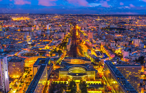 Tableau sur toile Aerial view of Gare Montparnasse illuminated by blue hour from panoramic Tour Montparnasse