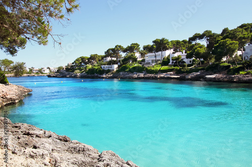 Beautiful Cala d'Or Beach in sunny summer day with turquoise water. Sandy beach Cala Gran in Cala d'Or, Mallorca, Spain.