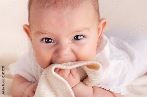 Принти на полотні Small cute funny baby infant teething with face expression hands and fingers in