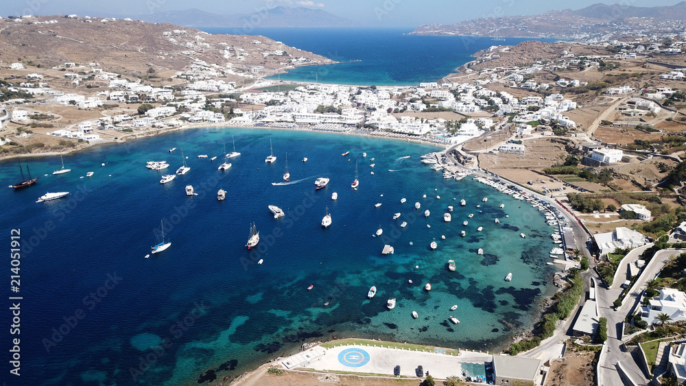 Fototapeta premium Aerial drone bird's eye view photo of famous organized with sun beds crystal clear water beach of Ornos in island of Mykonos, Cyclades, Greece