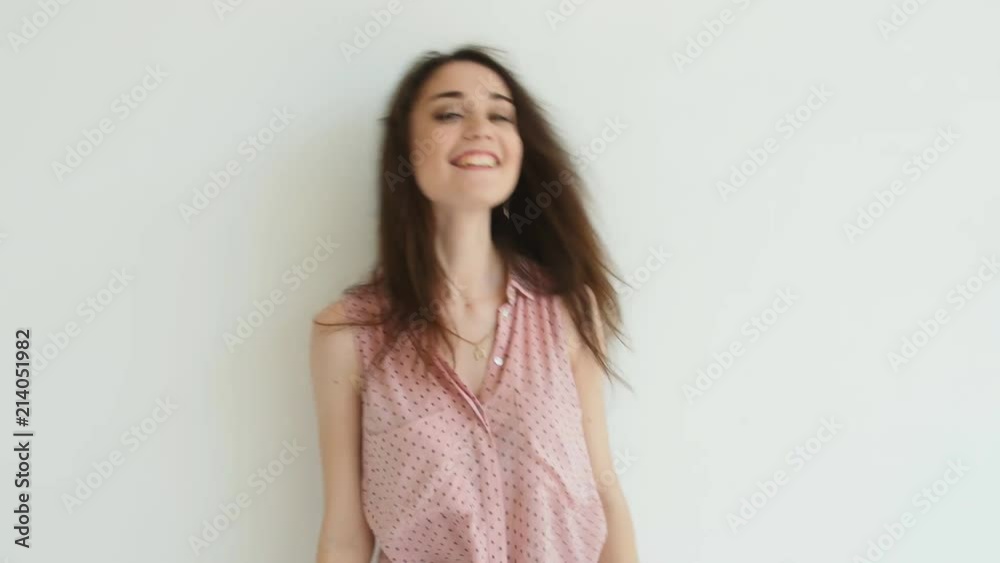 Young brunette woman dancing over white background Young brunette woman dancing over white background