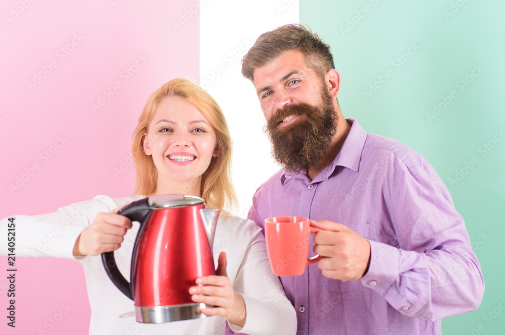 First thing they do every morning prepare hot drink. Get energy charge favourite hot drink. Enjoying morning coffee. Man with mug and woman with electric teapot ready to drink morning coffee First thing they do every morning prepare hot drink. Get energy charge favourite hot drink. Enjoying morning coffee. Man with mug and woman with electric teapot ready to drink morning coffee