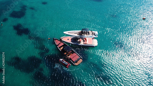 Aerial drone top view of docked inflatable speed boats in tropical emerald and sapphire sea © aerial-drone