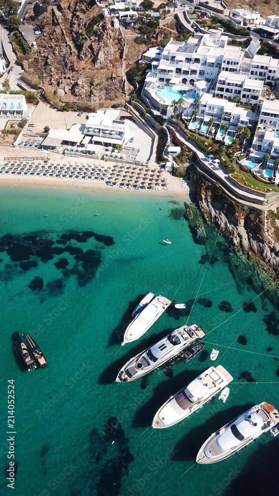 Aerial drone photo of famous turquoise clear water beach of Psarou in iconic island of Mykonos, Cyclades, Greece