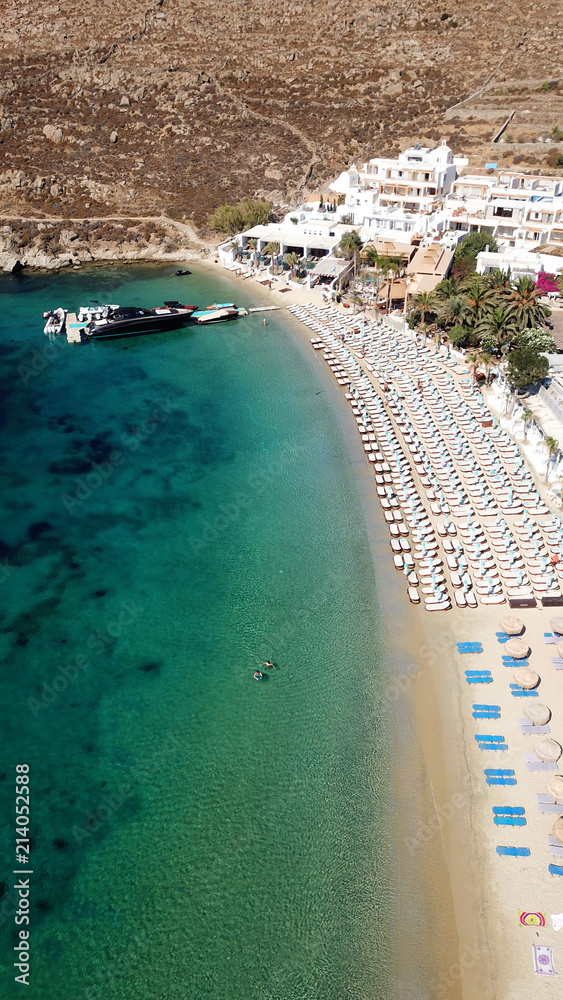 Aerial drone photo of famous turquoise clear water beach of Psarou in iconic island of Mykonos, Cyclades, Greece