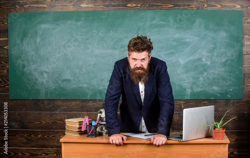 Konstfotografi Teacher strict serious bearded man lean on table chalkboard background