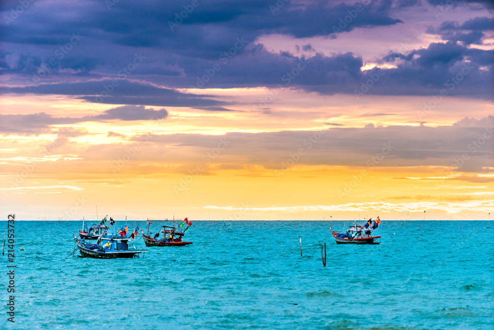 Fishing boat looking for fish in the evening sun goes down. The colorful sky on sunset hour. Fishing boat looking for fish in the evening sun goes down. The colorful sky on sunset hour.